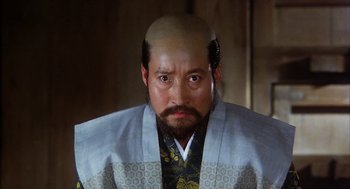 Movie still from “Kagemusha” (1980), directed by Akira Kurosawa – A person wearing a robe; Close Up shot, Low angle