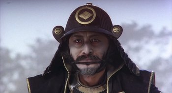 Movie still from “Kagemusha” (1980), directed by Akira Kurosawa – A person wearing a helmet; Close Up shot, Low angle