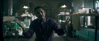 Movie still from “Keanu” (2016), directed by Peter Atencio – A man in a purple shirt and a yellow tie; Medium shot, Low angle
