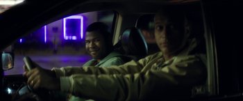 Movie still from “Keanu” (2016), directed by Peter Atencio – Two men sitting in the back seat of a car at night; Medium shot, Over the shoulder angle