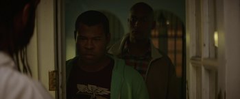 Movie still from “Keanu” (2016), directed by Peter Atencio – Two men standing next to each other in the dark; Medium shot, Over the shoulder angle