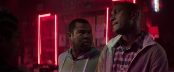 Movie still from “Keanu” (2016), directed by Peter Atencio – A couple of men standing next to each other in a room; Medium shot, Over the shoulder angle