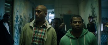 Movie still from “Keanu” (2016), directed by Peter Atencio – A group of men standing next to each other in a room; Medium shot, Low angle