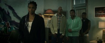 Movie still from “Keanu” (2016), directed by Peter Atencio – A group of people standing next to each other in a room; Medium shot, Over the shoulder angle
