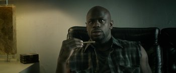 Movie still from “Keanu” (2016), directed by Peter Atencio – A man sitting in a chair holding a tooth brush; Close Up shot, Low angle