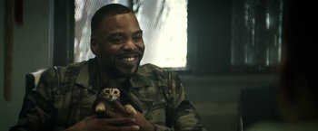 Movie still from “Keanu” (2016), directed by Peter Atencio – A man holding a small cat in his hands; Close Up shot, Low angle