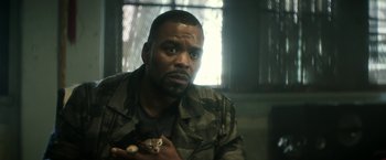 Movie still from “Keanu” (2016), directed by Peter Atencio – A man holding an animal in his hands; Close Up shot, Over the shoulder angle