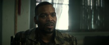 Movie still from “Keanu” (2016), directed by Peter Atencio – A person wearing a camouflage shirt; Close Up shot, Low angle