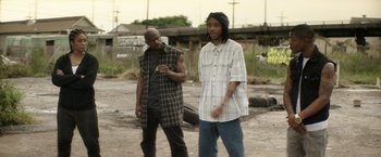Movie still from “Keanu” (2016), directed by Peter Atencio – Two young men standing in an empty lot; Wide shot, Over the shoulder angle