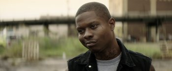 Movie still from “Keanu” (2016), directed by Peter Atencio – A person with a tattoo on his face; Close Up shot, Over the shoulder angle