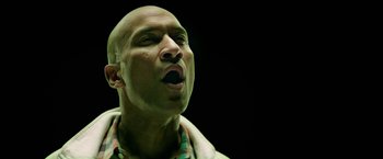 Movie still from “Keanu” (2016), directed by Peter Atencio – A bald man with his mouth wide open; Close Up shot, Low angle
