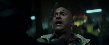 Movie still from “Keanu” (2016), directed by Peter Atencio – A bald man with a surprised look on his face; Close Up shot, Over the shoulder angle