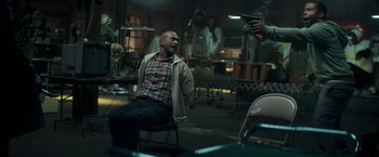 Movie still from “Keanu” (2016), directed by Peter Atencio – A man sitting on a chair in a room; Medium shot, Over the shoulder angle