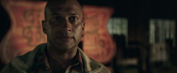 Movie still from “Keanu” (2016), directed by Peter Atencio – A man with a bald head is looking at the camera; Close Up shot, Low angle