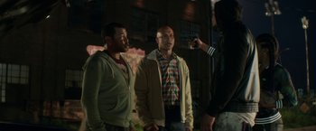 Movie still from “Keanu” (2016), directed by Peter Atencio – Two men standing next to each other in front of a camera; Medium shot, Over the shoulder angle