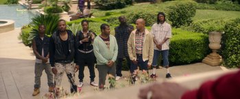 Movie still from “Keanu” (2016), directed by Peter Atencio – A group of people standing next to each other on a sidewalk; Wide shot, High angle