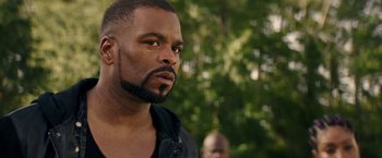 Movie still from “Keanu” (2016), directed by Peter Atencio – A man with a beard looking to his left; Close Up shot, Over the shoulder angle