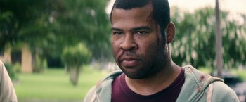 Movie still from “Keanu” (2016), directed by Peter Atencio – A person with a blood on his face; Close Up shot, Over the shoulder angle