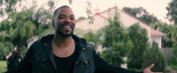 Movie still from “Keanu” (2016), directed by Peter Atencio – A man smiling for the camera while wearing a leather jacket; Close Up shot, Over the shoulder angle