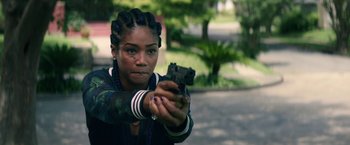 Movie still from “Keanu” (2016), directed by Peter Atencio – A woman holding a gun in her hand; Close Up shot, Over the shoulder angle