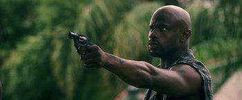 Movie still from “Keanu” (2016), directed by Peter Atencio – A man holding a gun in his hand; Close Up shot, Low angle