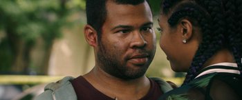 Movie still from “Keanu” (2016), directed by Peter Atencio – A person wearing a backpack; Close Up shot, Over the shoulder angle