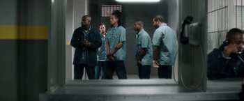 Movie still from “Keanu” (2016), directed by Peter Atencio – A group of men standing next to each other in a building; Wide shot, Low angle