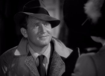 Movie still from “Keeper of the Flame” (1942), directed by George Cukor – A man wearing a hat and a coat; Close Up shot, Over the shoulder angle