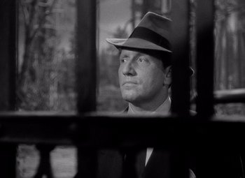 Movie still from “Keeper of the Flame” (1942), directed by George Cukor – A black and white photo of a man wearing a hat; Close Up shot, Low angle