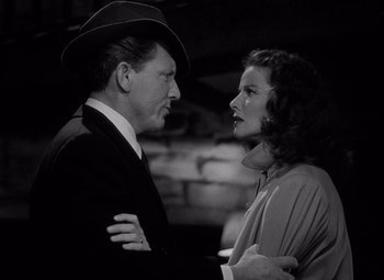 Movie still from “Keeper of the Flame” (1942), directed by George Cukor – A man and a woman standing next to each other; Medium shot, Low angle