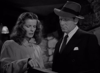 Movie still from “Keeper of the Flame” (1942), directed by George Cukor – A man and a woman looking at a piece of paper; Medium shot, Low angle