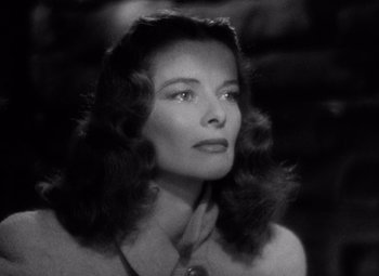 Movie still from “Keeper of the Flame” (1942), directed by George Cukor – A black - and - white photo of a woman with long hair; Close Up shot, Low angle