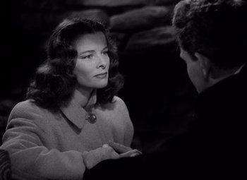 Movie still from “Keeper of the Flame” (1942), directed by George Cukor – A black - and - white photo of a woman talking to a man; Close Up shot, Over the shoulder angle