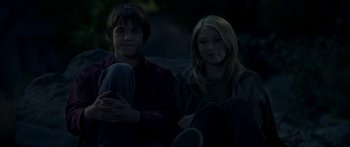 A man and a woman sitting next to each other on the ground