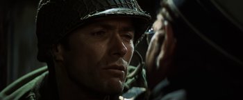 Movie still from “Kelly's Heroes” (1970), directed by Brian G. Hutton – A person wearing a helmet; Close Up shot, Over the shoulder angle