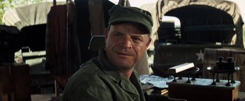 Movie still from “Kelly's Heroes” (1970), directed by Brian G. Hutton – A person wearing a hat; Close Up shot, Over the shoulder angle
