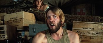 Movie still from “Kelly's Heroes” (1970), directed by Brian G. Hutton – A man with long hair and a goateed beard; Close Up shot, Low angle