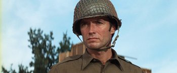 Movie still from “Kelly's Heroes” (1970), directed by Brian G. Hutton – A man wearing a military helmet and a uniform; Close Up shot, Low angle