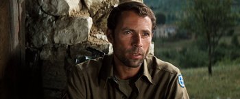 Movie still from “Kelly's Heroes” (1970), directed by Brian G. Hutton – A person wearing a brown shirt; Close Up shot, Over the shoulder angle