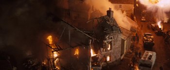 Movie still from “Kelly's Heroes” (1970), directed by Brian G. Hutton – A house on fire in a city at night; Extreme Wide shot, High angle