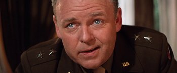 Movie still from “Kelly's Heroes” (1970), directed by Brian G. Hutton – A person wearing a military uniform; Close Up shot, Low angle