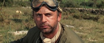 Movie still from “Kelly's Heroes” (1970), directed by Brian G. Hutton – A person wearing goggles and a jacket; Close Up shot, Low angle
