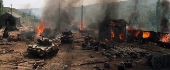 Movie still from “Kelly's Heroes” (1970), directed by Brian G. Hutton – Tanks are burning in the middle of a field; Extreme Wide shot, High angle