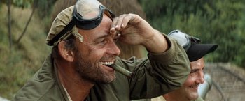 Movie still from “Kelly's Heroes” (1970), directed by Brian G. Hutton – A man with a pipe in his mouth; Close Up shot, Low angle