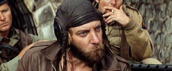 Movie still from “Kelly's Heroes” (1970), directed by Brian G. Hutton – A man with a beard wearing a leather hat; Close Up shot, Low angle