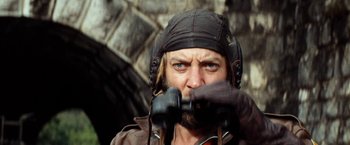 Movie still from “Kelly's Heroes” (1970), directed by Brian G. Hutton – A person wearing a hat and holding binoculars; Close Up shot, Low angle