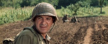 Movie still from “Kelly's Heroes” (1970), directed by Brian G. Hutton – A man wearing a helmet in the middle of a field; Close Up shot, Low angle