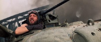 Movie still from “Kelly's Heroes” (1970), directed by Brian G. Hutton – A man in a helmet is leaning on a tank; Close Up shot, Low angle