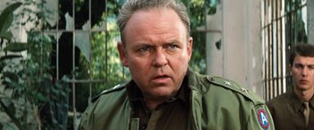 Movie still from “Kelly's Heroes” (1970), directed by Brian G. Hutton – An older man in a green jacket looking at the camera; Close Up shot, Low angle