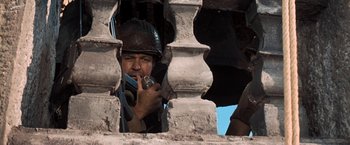Movie still from “Kelly's Heroes” (1970), directed by Brian G. Hutton – A man in a helmet is looking through a window; Close Up shot, Low angle